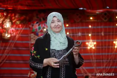 Palestinian woman Laila Shaheen, displays the artifacts and traditional clothes in her museum "Rafah Museum" on the Palestinian Costume Day, in the city of Rafah, in the southern Gaza Strip on July 25, 2023. Shaheen is t...
