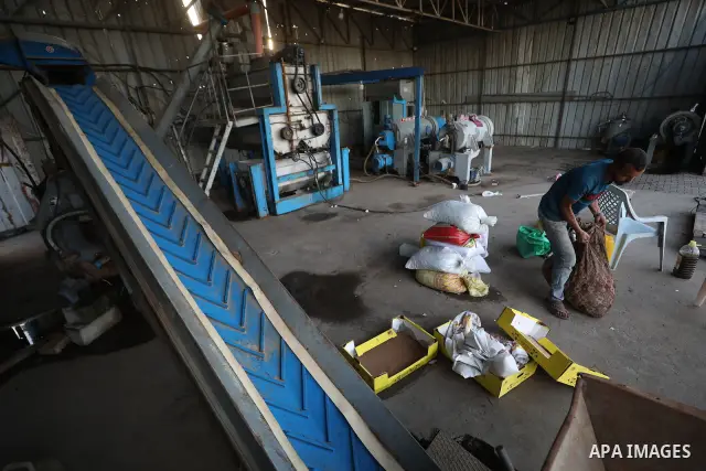 A Palestinian worker repairs and maintains olive pressing machines in Deir el-Balah, central Gaza Strip, on September 27, 2026, ahead of the olive harvest season. A number of olive presses were damaged by Israeli airstri...