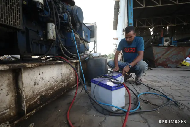 A Palestinian worker repairs and maintains olive pressing machines in Deir el-Balah, central Gaza Strip, on September 27, 2026, ahead of the olive harvest season. A number of olive presses were damaged by Israeli airstri...