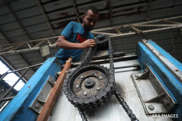 A Palestinian worker repairs and maintains olive pressing machines in Deir el-Balah, central Gaza Strip, on September 27, 2026, ahead of the olive harvest season. A number of olive presses were damaged by Israeli airstri...