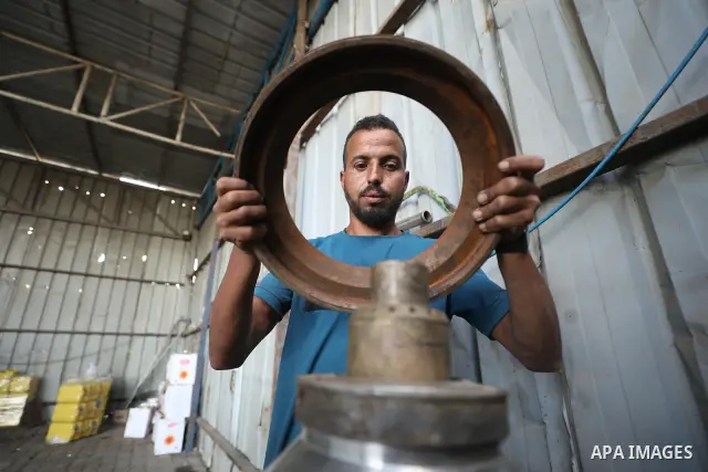 A Palestinian worker repairs and maintains olive pressing machines in Deir el-Balah, central Gaza Strip, on September 27, 2026, ahead of the olive harvest season. A number of olive presses were damaged by Israeli airstri...