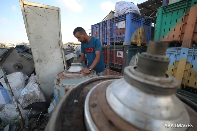 A Palestinian worker repairs and maintains olive pressing machines in Deir el-Balah, central Gaza Strip, on September 27, 2026, ahead of the olive harvest season. A number of olive presses were damaged by Israeli airstri...