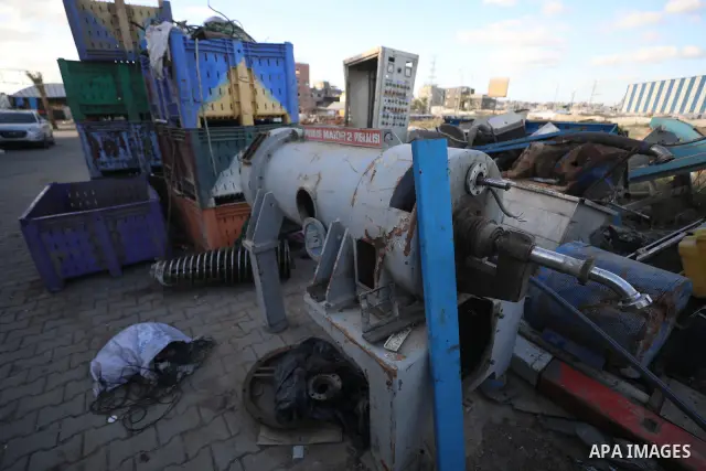 A Palestinian worker repairs and maintains olive pressing machines in Deir el-Balah, central Gaza Strip, on September 27, 2026, ahead of the olive harvest season. A number of olive presses were damaged by Israeli airstri...