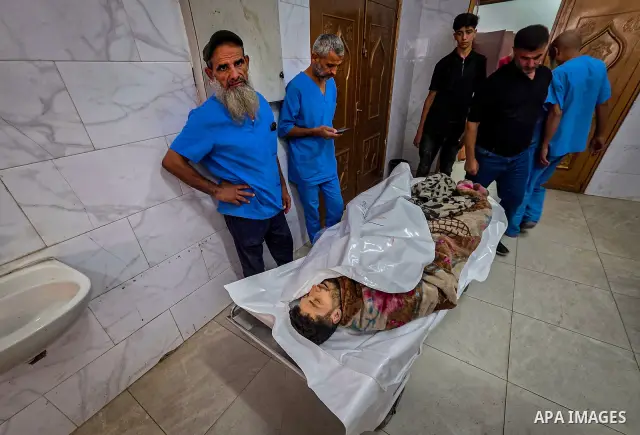 Palestinians carry the body of 28-year-old Oday Adli al-Assar to Nasser Medical Complex in Khan Younis, southern Gaza Strip, on September 27, 2026, after he was killed in an Israeli airstrike that targeted a group of Pal...