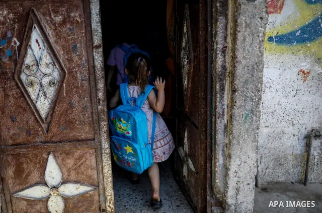 Palestinian visual artist Hala Abu Hamda, 18, paints and colors children’s bags inside her home in the al-Nasr neighborhood of Gaza City on September 27, 2026, as the new academic year begins. Students in the Gaza Strip...