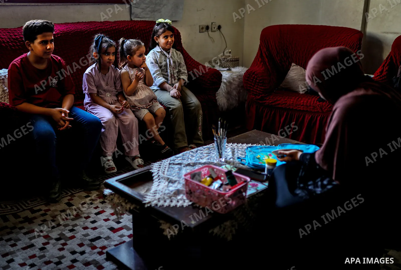 Palestinian visual artist Hala Abu Hamda, 18, paints and colors children’s bags inside her home in the al-Nasr neighborhood of Gaza City on September 27, 2026, as the new academic year begins. Students in the Gaza Strip...