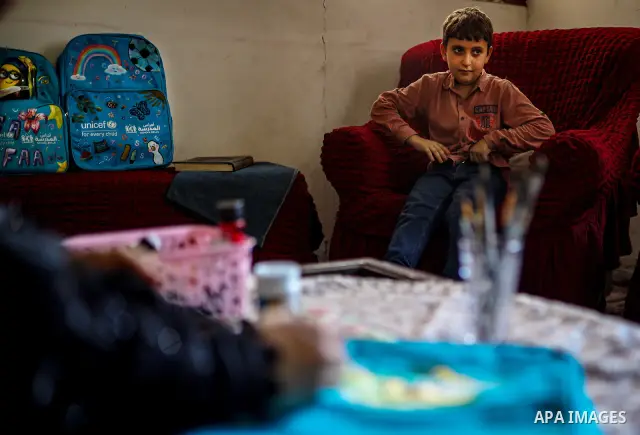 Palestinian visual artist Hala Abu Hamda, 18, paints and colors children’s bags inside her home in the al-Nasr neighborhood of Gaza City on September 27, 2026, as the new academic year begins. Students in the Gaza Strip...