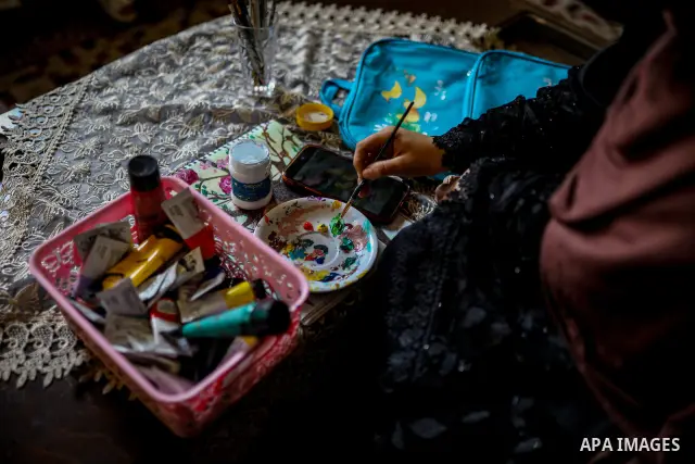 Palestinian visual artist Hala Abu Hamda, 18, paints and colors children’s bags inside her home in the al-Nasr neighborhood of Gaza City on September 27, 2026, as the new academic year begins. Students in the Gaza Strip...