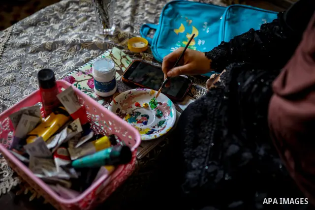 Palestinian visual artist Hala Abu Hamda, 18, paints and colors children’s bags inside her home in the al-Nasr neighborhood of Gaza City on September 27, 2026, as the new academic year begins. Students in the Gaza Strip...