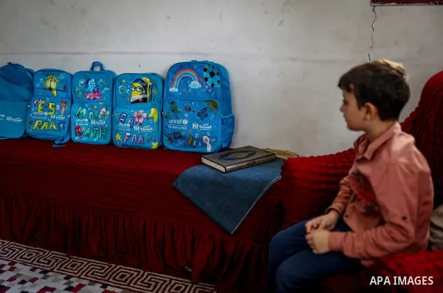 Palestinian visual artist Hala Abu Hamda, 18, paints and colors children’s bags inside her home in the al-Nasr neighborhood of Gaza City on September 27, 2026, as the new academic year begins. Students in the Gaza Strip...