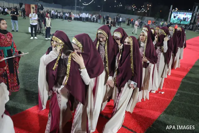 Brides and grooms take part in a mass wedding ceremony for 44 couples in Dura, near the West Bank city of Hebron, on September 26, 2026. Thousands of family members, residents and friends attended the celebration to mark...