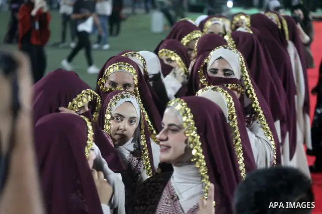 Brides and grooms take part in a mass wedding ceremony for 44 couples in Dura, near the West Bank city of Hebron, on September 26, 2026. Thousands of family members, residents and friends attended the celebration to mark...