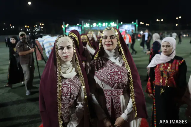 Brides and grooms take part in a mass wedding ceremony for 44 couples in Dura, near the West Bank city of Hebron, on September 26, 2026. Thousands of family members, residents and friends attended the celebration to mark...