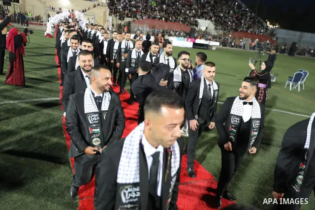 Brides and grooms take part in a mass wedding ceremony for 44 couples in Dura, near the West Bank city of Hebron, on September 26, 2026. Thousands of family members, residents and friends attended the celebration to mark...