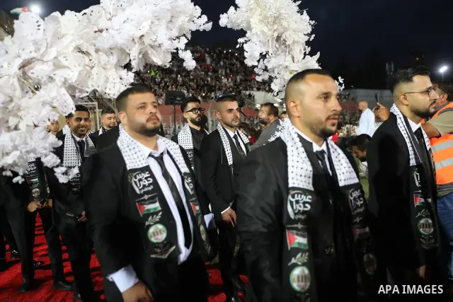 Brides and grooms take part in a mass wedding ceremony for 44 couples in Dura, near the West Bank city of Hebron, on September 26, 2026. Thousands of family members, residents and friends attended the celebration to mark...