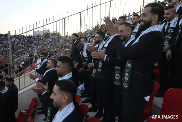 Brides and grooms take part in a mass wedding ceremony for 44 couples in Dura, near the West Bank city of Hebron, on September 26, 2026. Thousands of family members, residents and friends attended the celebration to mark...