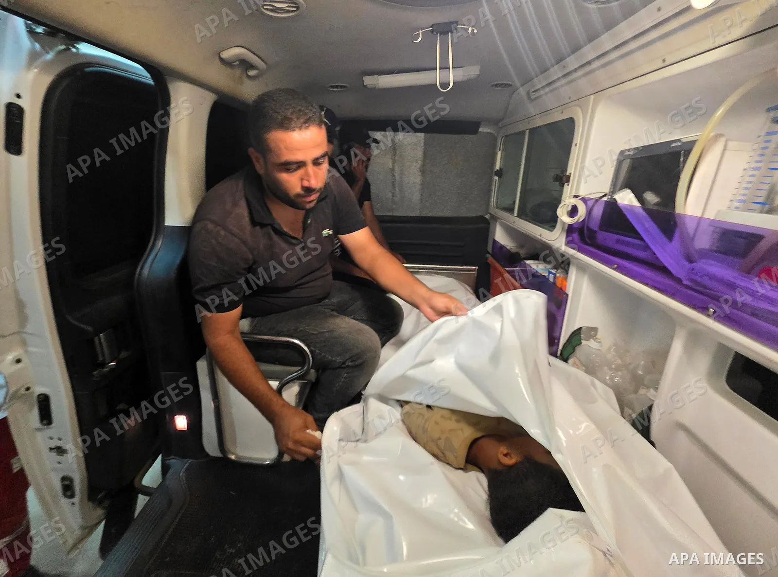 Medics carry the body of eight-year-old Mohammed Seif al-Din al-Shukhriti to Nasser Medical Complex in Khan Younis, southern Gaza Strip, on September 26, 2026, after he was killed by Israeli gunfire while playing outside...