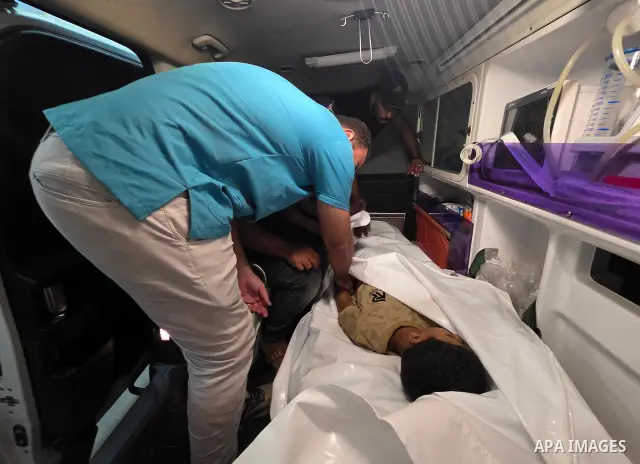 Medics carry the body of eight-year-old Mohammed Seif al-Din al-Shukhriti to Nasser Medical Complex in Khan Younis, southern Gaza Strip, on September 26, 2026, after he was killed by Israeli gunfire while playing outside...