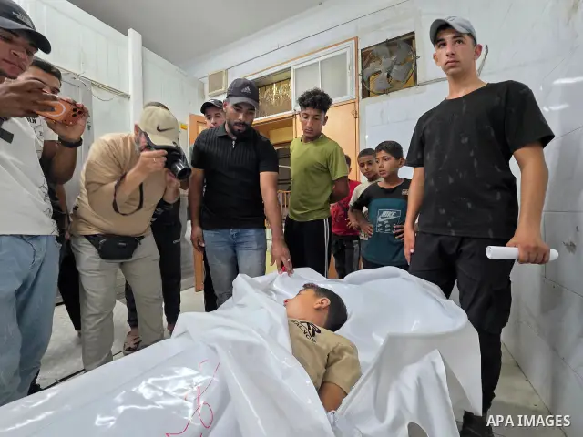 Medics carry the body of eight-year-old Mohammed Seif al-Din al-Shukhriti to Nasser Medical Complex in Khan Younis, southern Gaza Strip, on September 26, 2026, after he was killed by Israeli gunfire while playing outside...
