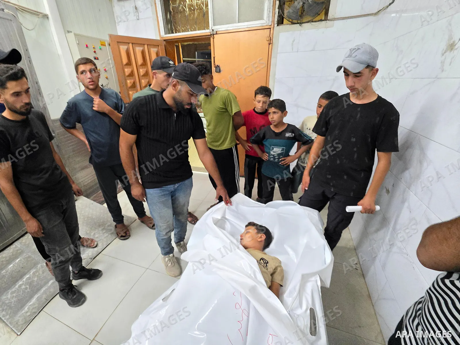 Medics carry the body of eight-year-old Mohammed Seif al-Din al-Shukhriti to Nasser Medical Complex in Khan Younis, southern Gaza Strip, on September 26, 2026, after he was killed by Israeli gunfire while playing outside...