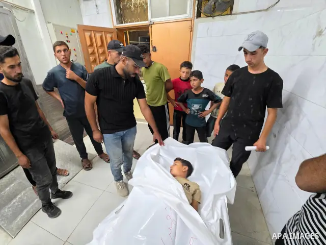 Medics carry the body of eight-year-old Mohammed Seif al-Din al-Shukhriti to Nasser Medical Complex in Khan Younis, southern Gaza Strip, on September 26, 2026, after he was killed by Israeli gunfire while playing outside...
