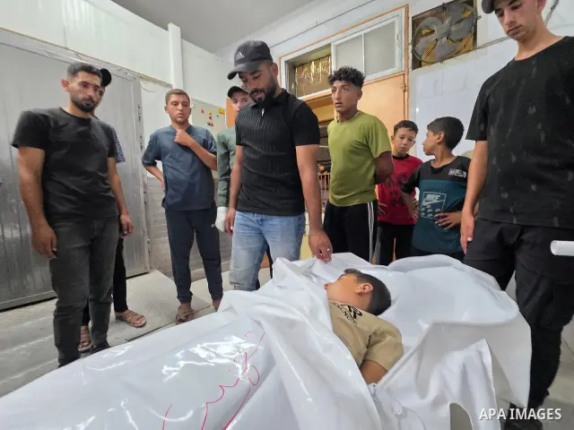 Medics carry the body of eight-year-old Mohammed Seif al-Din al-Shukhriti to Nasser Medical Complex in Khan Younis, southern Gaza Strip, on September 26, 2026, after he was killed by Israeli gunfire while playing outside...