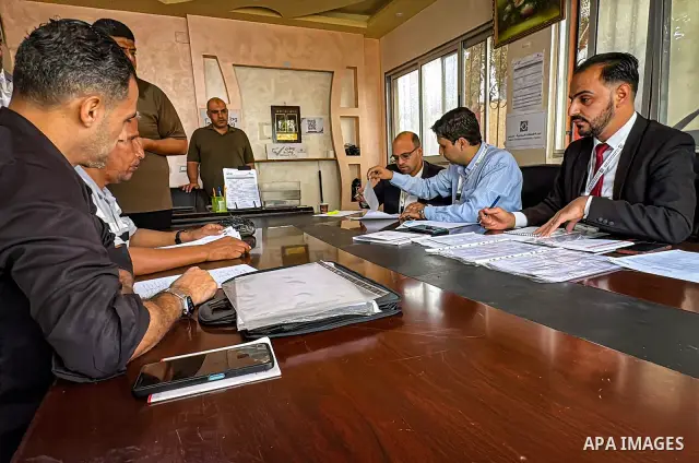 Palestinians submit nomination applications for their electoral lists for the 2026 legislative elections at the Central Elections Commission office in Deir el-Balah, central Gaza Strip, on September 26, 2026. The commiss...