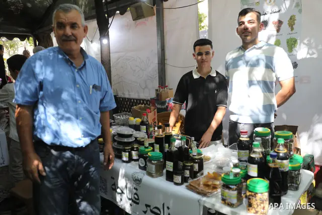 Palestinian farmers and residents take part in a grape festival in the Old City of Hebron, West Bank, on September 26, 2026, celebrating the grape harvest for which the area is known. The festival featured various grape...