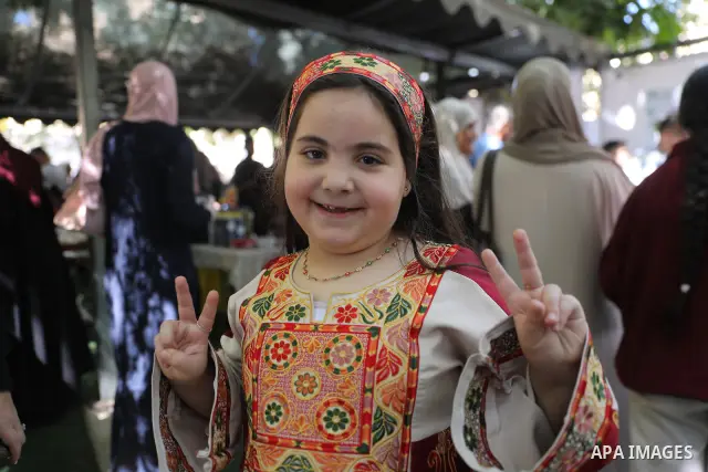 Palestinian farmers and residents take part in a grape festival in the Old City of Hebron, West Bank, on September 26, 2026, celebrating the grape harvest for which the area is known. The festival featured various grape...