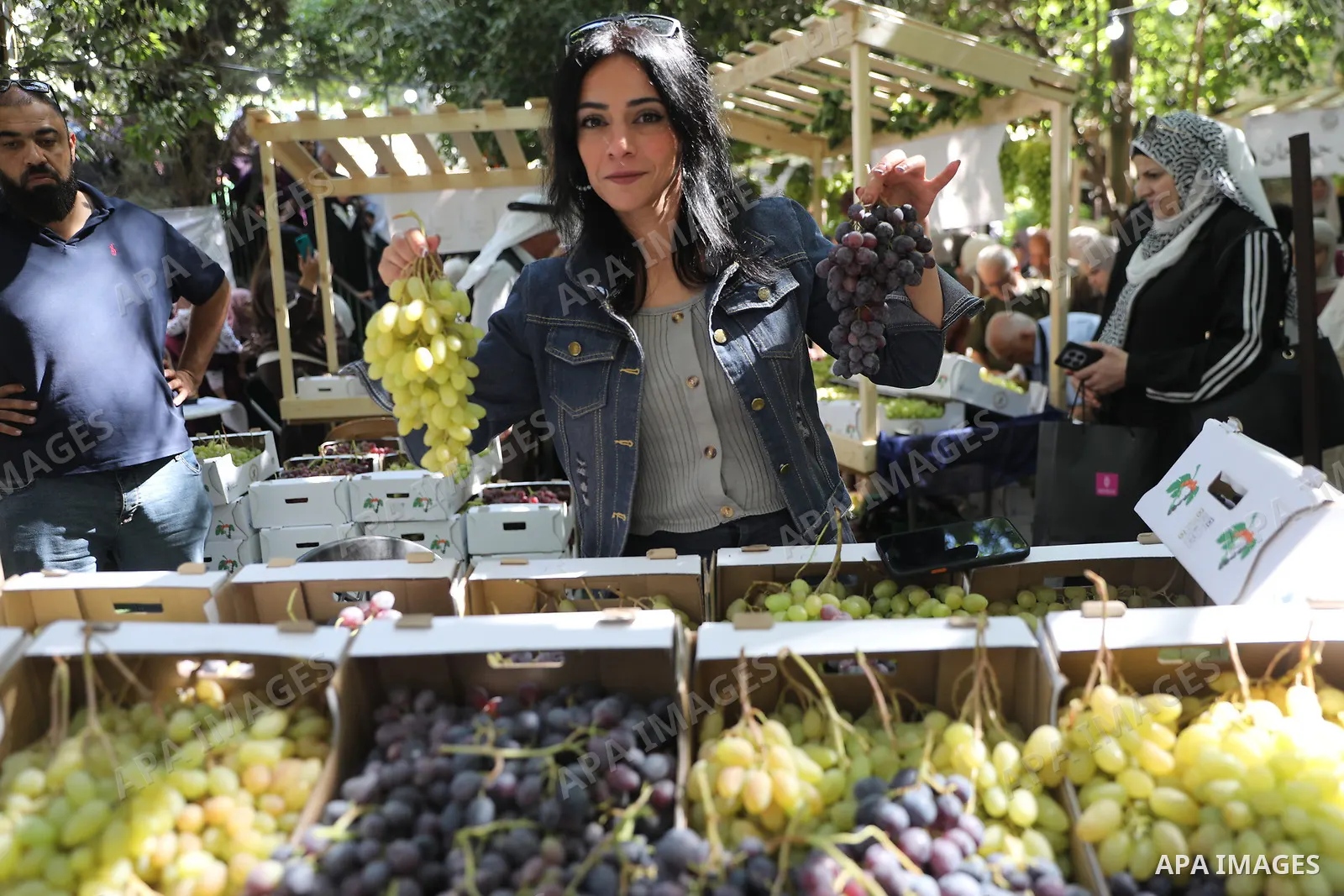 Palestinian farmers and residents take part in a grape festival in the Old City of Hebron, West Bank, on September 26, 2026, celebrating the grape harvest for which the area is known. The festival featured various grape...
