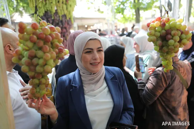 Palestinian farmers and residents take part in a grape festival in the Old City of Hebron, West Bank, on September 26, 2026, celebrating the grape harvest for which the area is known. The festival featured various grape...
