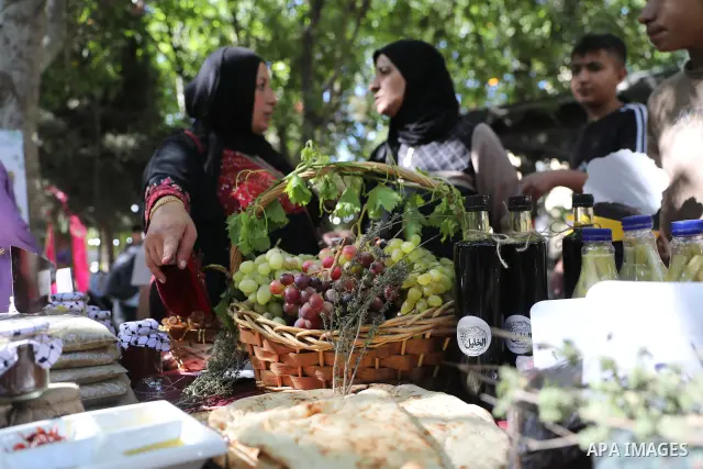 Palestinian farmers and residents take part in a grape festival in the Old City of Hebron, West Bank, on September 26, 2026, celebrating the grape harvest for which the area is known. The festival featured various grape...