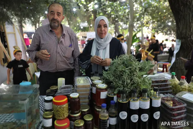 Palestinian farmers and residents take part in a grape festival in the Old City of Hebron, West Bank, on September 26, 2026, celebrating the grape harvest for which the area is known. The festival featured various grape...