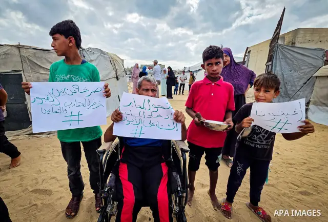 Displaced Palestinians bang on cooking pots during a protest at a cemetery in Khan Younis, southern Gaza Strip, on September 26, 2026, calling for improved living conditions in displacement tents as winter approaches. Th...