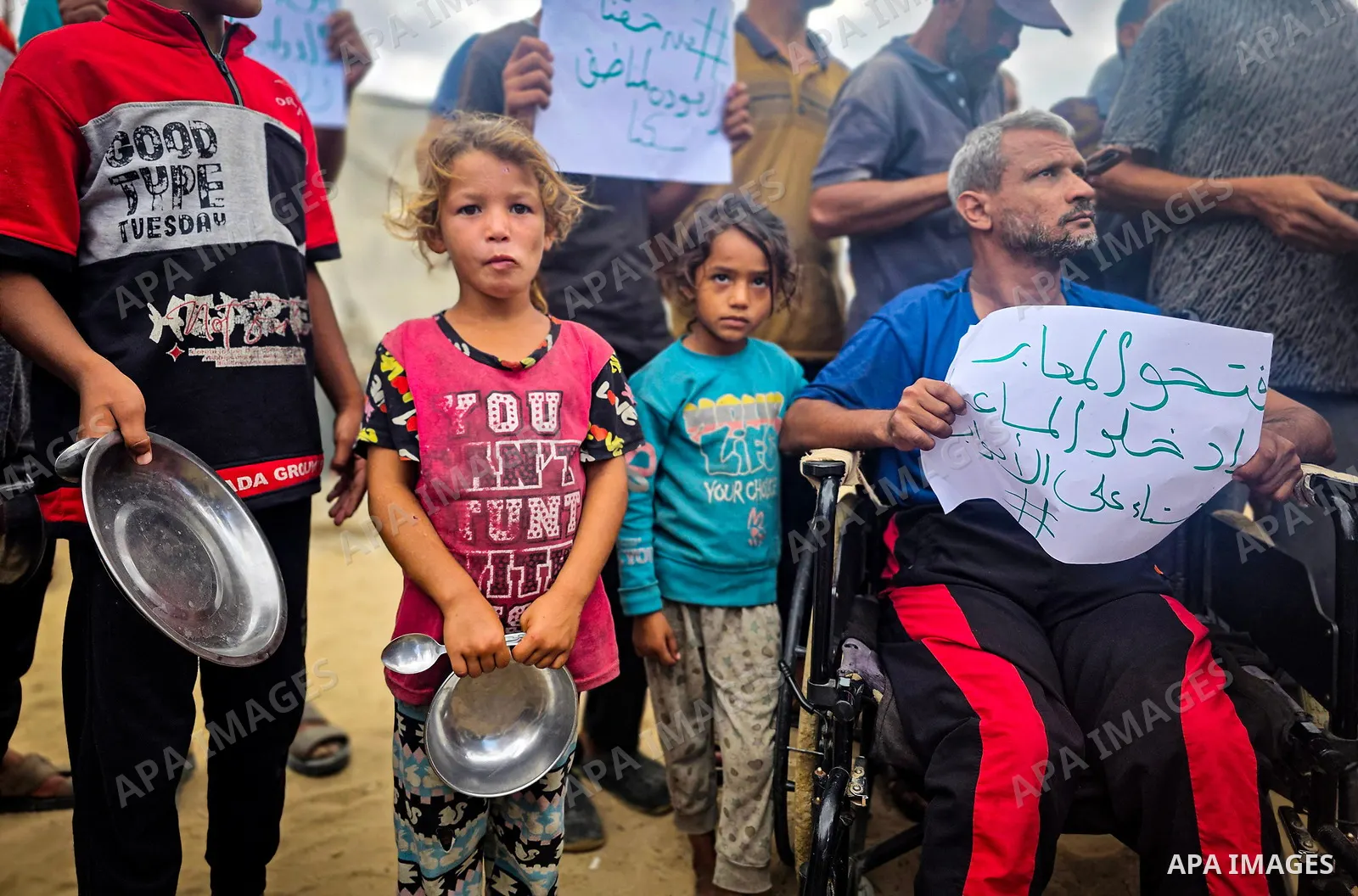 Displaced Palestinians bang on cooking pots during a protest at a cemetery in Khan Younis, southern Gaza Strip, on September 26, 2026, calling for improved living conditions in displacement tents as winter approaches. Th...