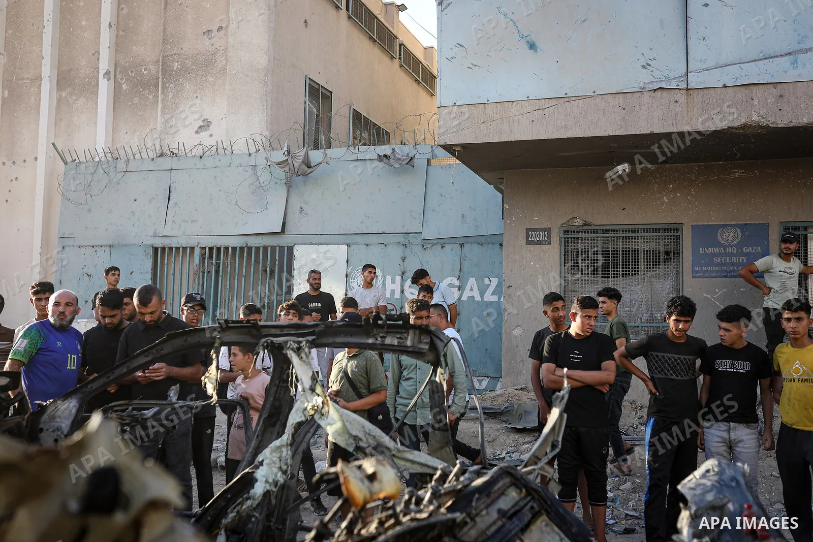 Palestinians gather at the site of an Israeli airstrike that targeted a vehicle near al-Sinaa junction in Gaza City on September 27, 2026. The strike killed one Palestinian and wounded others, according to local sources....