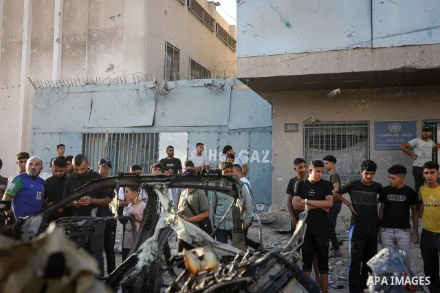 Palestinians gather at the site of an Israeli airstrike that targeted a vehicle near al-Sinaa junction in Gaza City on September 27, 2026. The strike killed one Palestinian and wounded others, according to local sources....