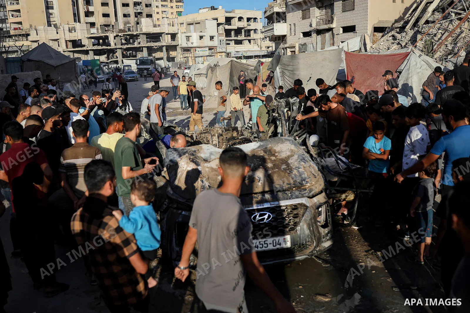 Palestinians gather at the site of an Israeli airstrike that targeted a vehicle near al-Sinaa junction in Gaza City on September 27, 2026. The strike killed one Palestinian and wounded others, according to local sources....