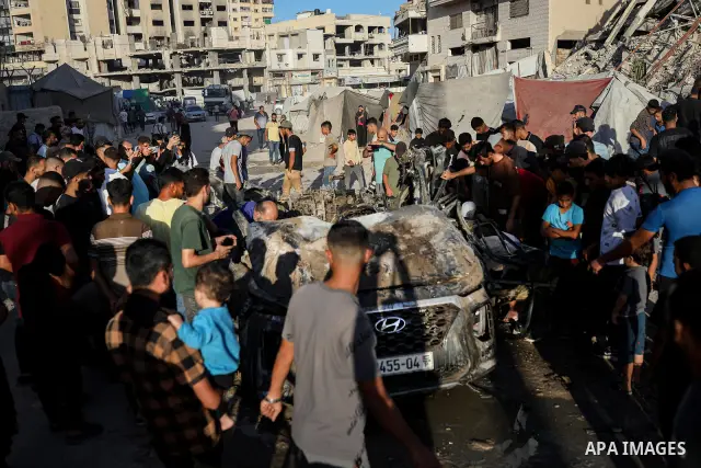 Palestinians gather at the site of an Israeli airstrike that targeted a vehicle near al-Sinaa junction in Gaza City on September 27, 2026. The strike killed one Palestinian and wounded others, according to local sources....