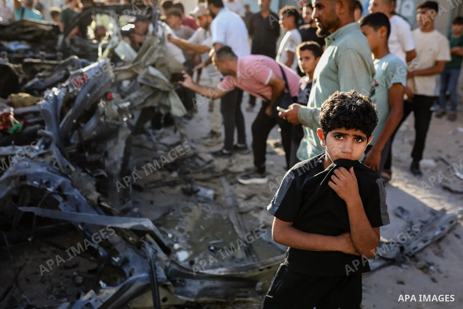 Palestinians gather at the site of an Israeli airstrike that targeted a vehicle near al-Sinaa junction in Gaza City on September 27, 2026. The strike killed one Palestinian and wounded others, according to local sources....