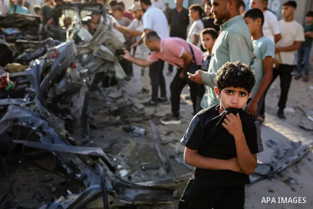 Palestinians gather at the site of an Israeli airstrike that targeted a vehicle near al-Sinaa junction in Gaza City on September 27, 2026. The strike killed one Palestinian and wounded others, according to local sources....