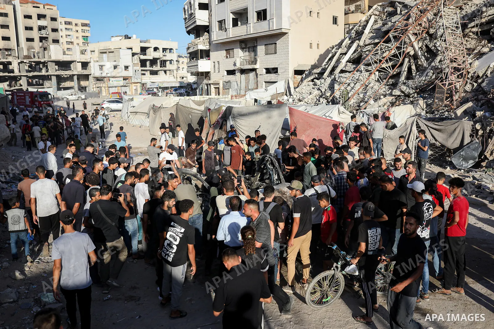 Palestinians gather at the site of an Israeli airstrike that targeted a vehicle near al-Sinaa junction in Gaza City on September 27, 2026. The strike killed one Palestinian and wounded others, according to local sources....