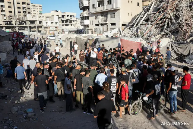 Palestinians gather at the site of an Israeli airstrike that targeted a vehicle near al-Sinaa junction in Gaza City on September 27, 2026. The strike killed one Palestinian and wounded others, according to local sources....