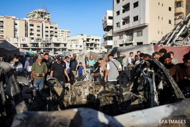 Palestinians gather at the site of an Israeli airstrike that targeted a vehicle near al-Sinaa junction in Gaza City on September 27, 2026. The strike killed one Palestinian and wounded others, according to local sources....