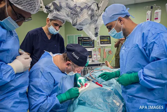 A medical team performs cochlear implant surgery on a child at Nasser Medical Complex in Khan Younis, southern Gaza Strip, on September 27, 2026. The operation is part of a project to provide similar surgeries for 50 chi...