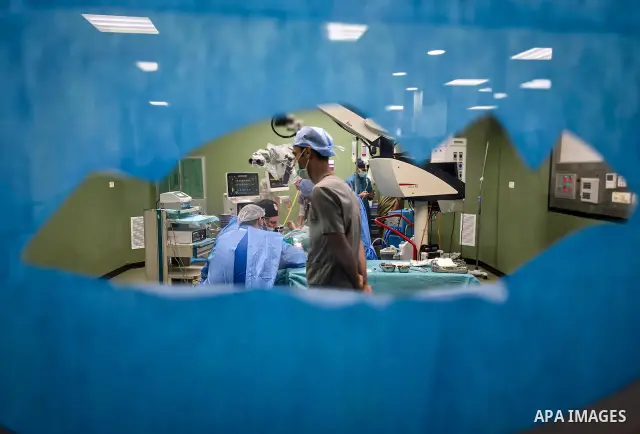 A medical team performs cochlear implant surgery on a child at Nasser Medical Complex in Khan Younis, southern Gaza Strip, on September 27, 2026. The operation is part of a project to provide similar surgeries for 50 chi...