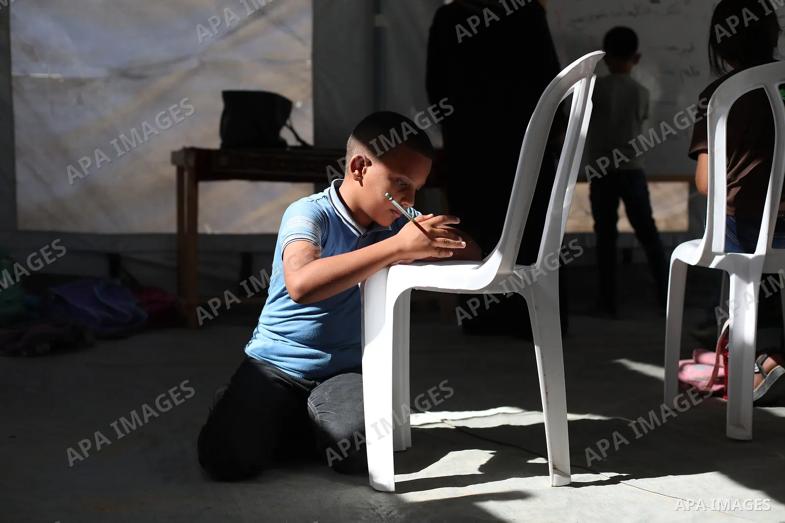 Palestinian students attend a lesson inside a tent in al-Bureij camp in the central Gaza Strip on September 26, 2026, as the new academic year resumes. Classes are being held amid widespread damage to schools and shortag...