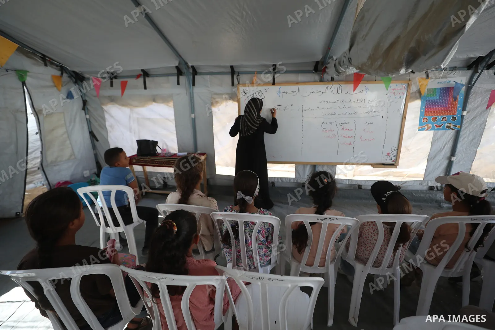 Palestinian students attend a lesson inside a tent in al-Bureij camp in the central Gaza Strip on September 26, 2026, as the new academic year resumes. Classes are being held amid widespread damage to schools and shortag...