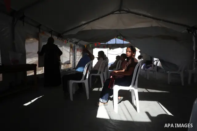 Palestinian students attend a lesson inside a tent in al-Bureij camp in the central Gaza Strip on September 26, 2026, as the new academic year resumes. Classes are being held amid widespread damage to schools and shortag...