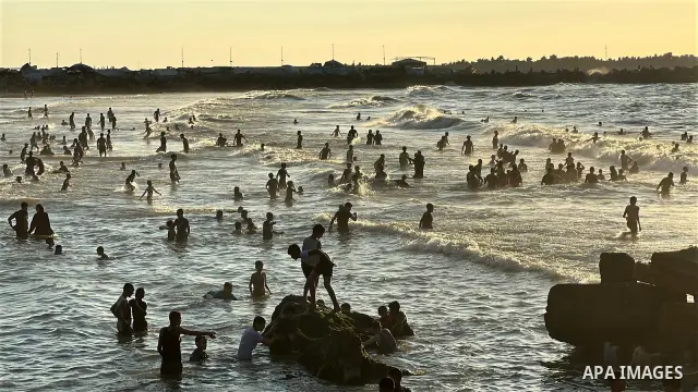 Displaced Palestinians spend time on the beach in Gaza City, in the Gaza Strip, on September 25, 2026, seeking relief from high temperatures and difficult living conditions inside displacement and shelter tents. Many dis...